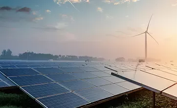 Solar panels with wind turbine in abckground