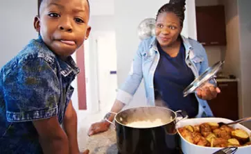child and adult with a home-cooked meal