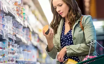 Woman is picking up the products in the market