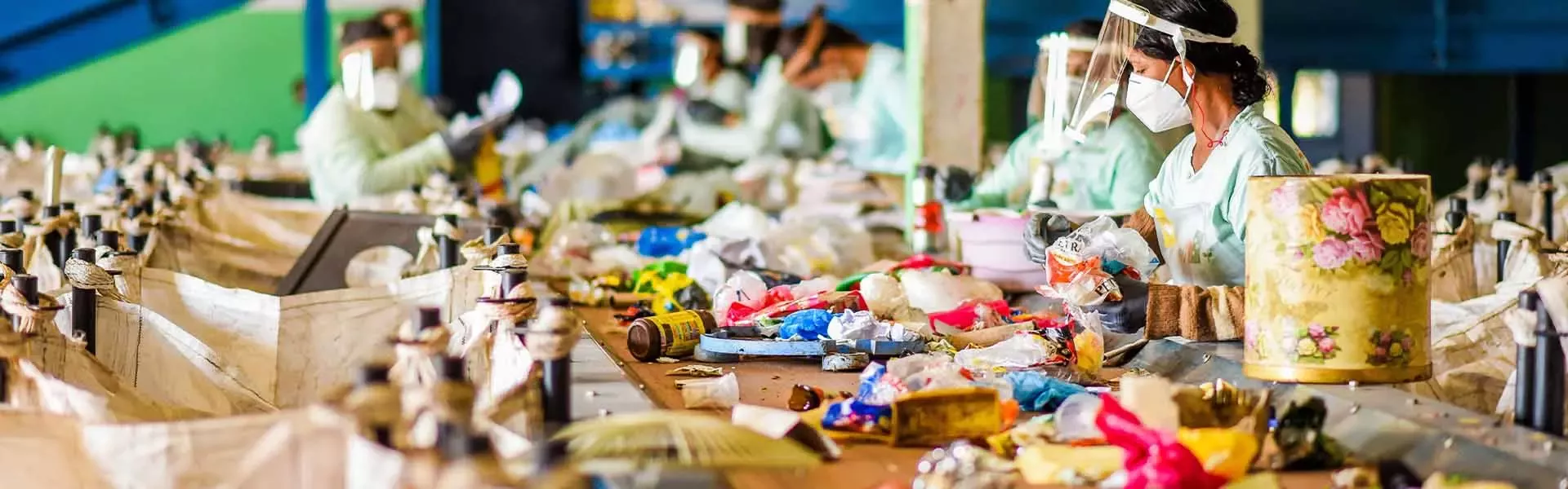 Workers sorting recyclables at processing plant
