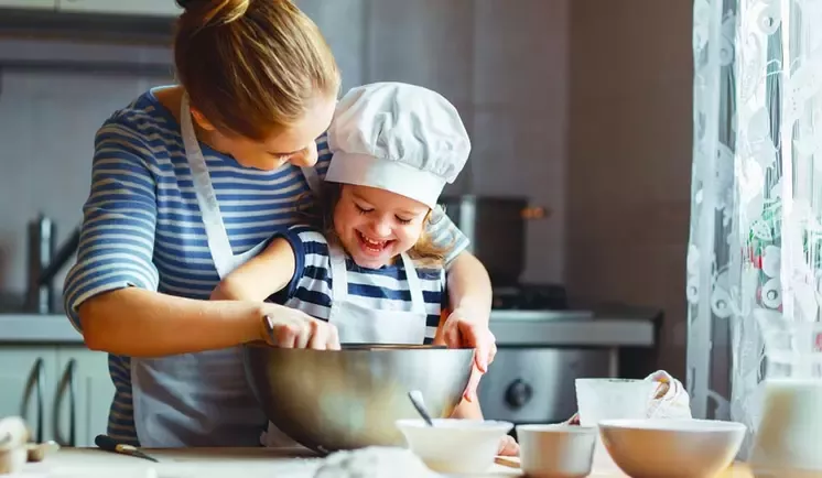child and adult in a kitchen