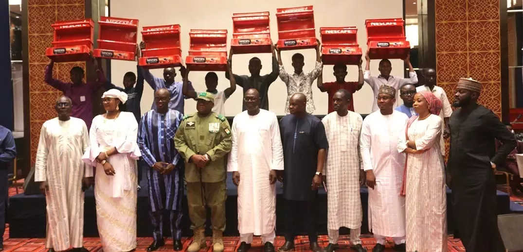 People in Niger holding Nescafe packs