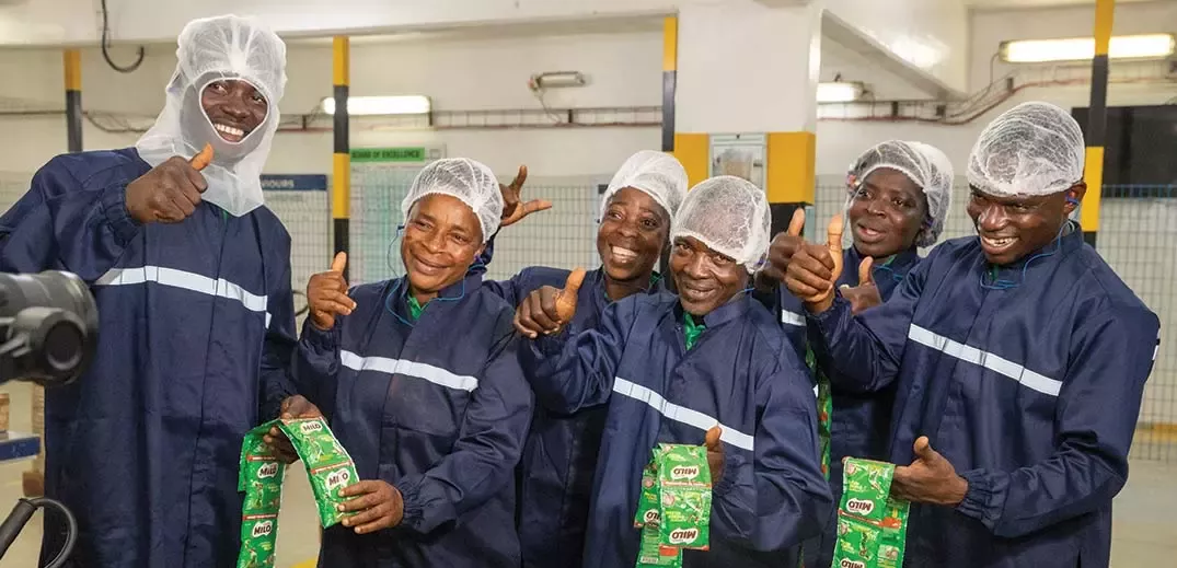 Ketewa farmers hold milo products on a farm