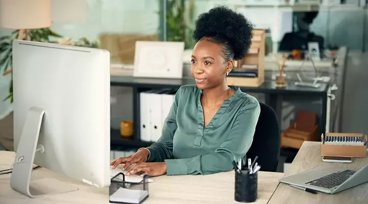 Businesswoman working at office desktop computer