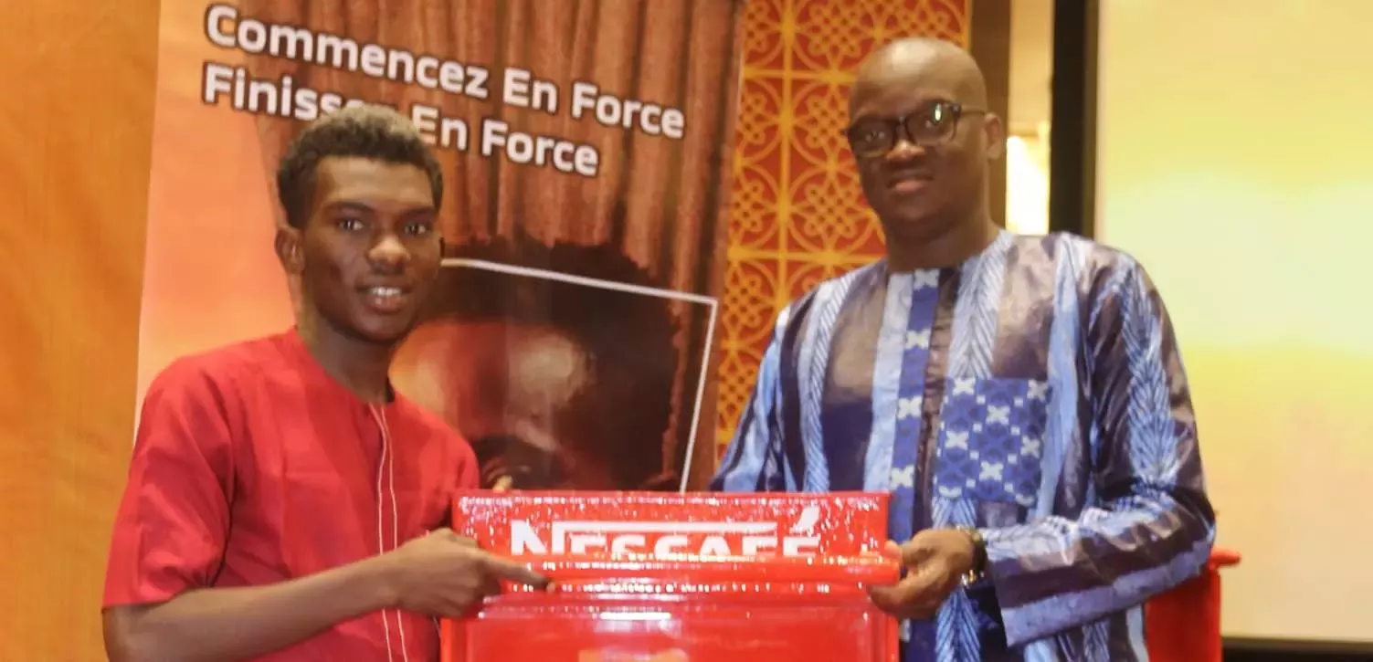Two men holding Nescafe big pack
